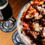 Professional videography pizza and beverage on wooden table