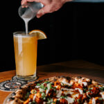 Professional videography capturing delicious pizza and drink