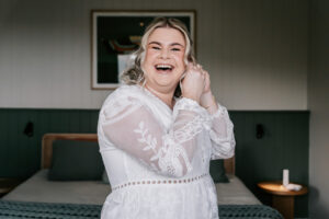 Professional videography capturing joyful bride getting ready