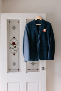 Professional videography photography and drone footage navy suit on door