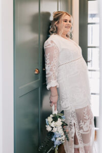 Professional videography; bride in lace gown holding bouquet