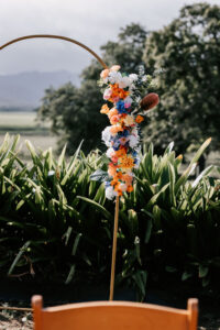 Professional videography captures vibrant outdoor floral archway