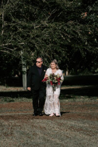 Professional videography captures bride walking with a guest