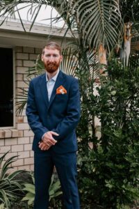 Professional videography portrait of man in blue suit outdoors