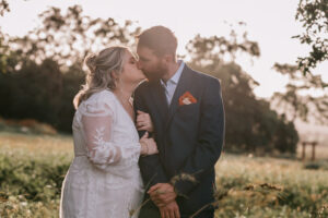 Professional videography and photography capturing a wedding kiss
