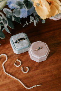 Professional videography and wedding jewelry display on table