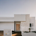 Professional videography captures modern white home exterior