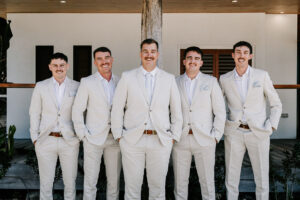 Professional videography group in light suits at outdoor event