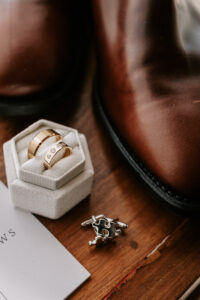 Professional videography wedding rings with groom's accessories