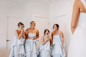 Professional videography bridesmaids react with joy and surprise