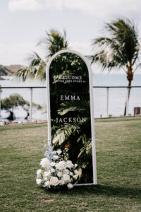 Professional videography destination wedding sign by the ocean