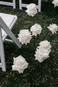 Professional videography, photography, and drone footage white roses at wedding ceremony on the ground