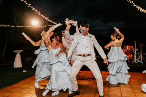 Professional videography of a lively outdoor wedding dance party