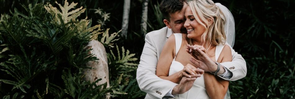 Professional videography wedding couple embraces in lush garden