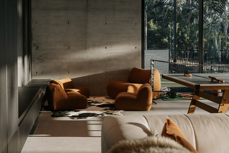 Fortunato bedroom with warm interior finishes and views through glass doors, photographed by TDM