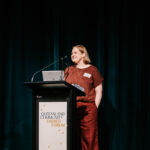 Professional videography speaker at energy forum presentation stage