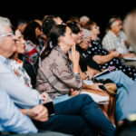 Professional videography photographing audience at event session
