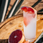 Professional videography fresh grapefruit cocktail on wooden table