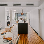 Kitchen and dining area at 208 Boathouse looking towards the Port of Airlie marina