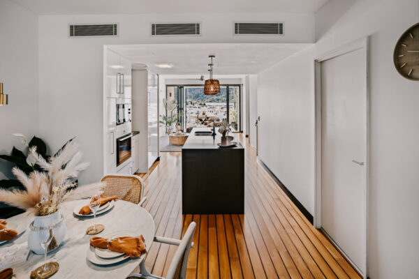 Kitchen and dining area at 208 Boathouse looking towards the Port of Airlie marina