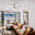 Living room and balcony with marina views at 208 Boathouse