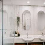 Bathroom with twin basins and oval mirrors at 208 Boathouse