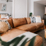 Tan leather sofa in the living area at 208 Boathouse