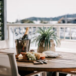 Outdoor dining table and marina view at 208 Boathouse