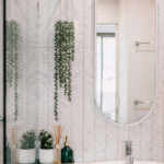 Bathroom basin and oval mirror at 208 Boathouse