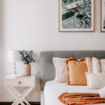208 Boathouse bedroom with orange cushions and a matching throw