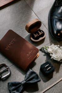 Professional videography wedding details with rings and vows book
