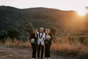 Professional videography, photography, and drone footage of wedding party at sunset in scenic landscape