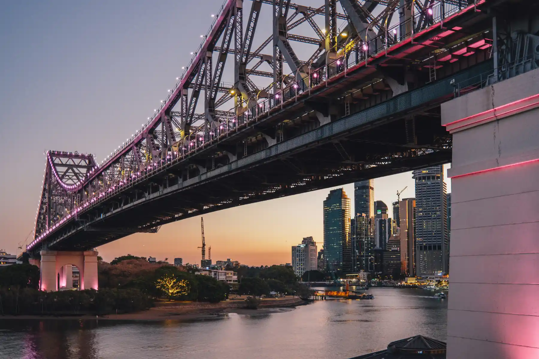 Brisbane’s illuminated Story Bridge above the river and city skyline at dusk