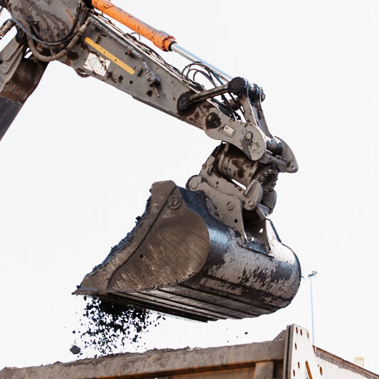 Digger scoop dropping coal into awaiting haul truck
