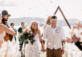 bride and groom walk down aisle