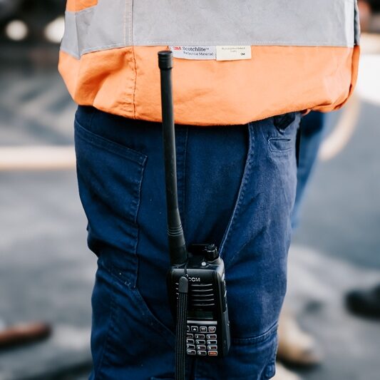 man wearing hi vis with icon air radio on pants pocket