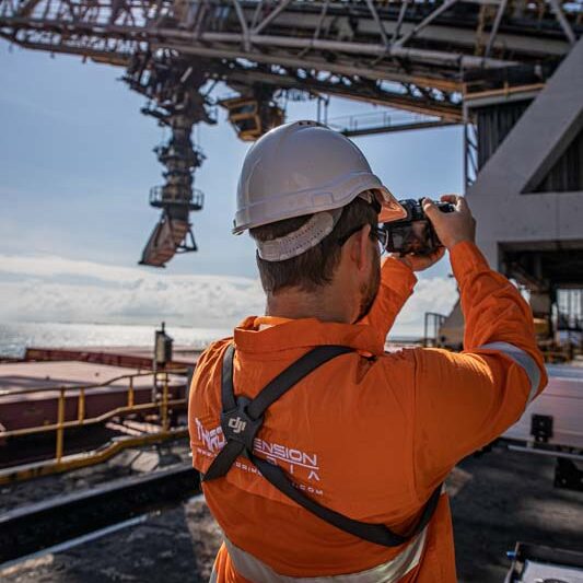 man in PPE using camera