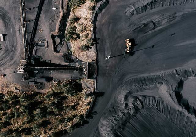 Aerial view of coal belt being loaded by shovel truck on mine site